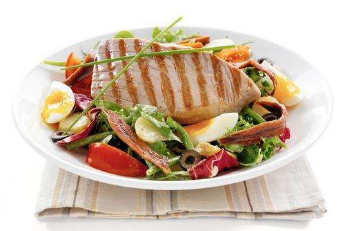 a plate of salad with meat and vegetables