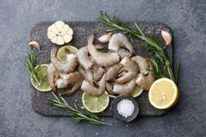 King Prawns on a slate board with limes & rosemary