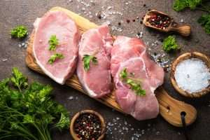 Pork steaks on a wooden board