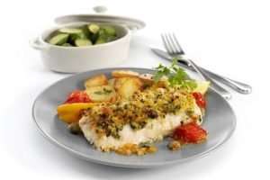 a plate of food with a bowl of vegetables and a fork and Haddock Loin