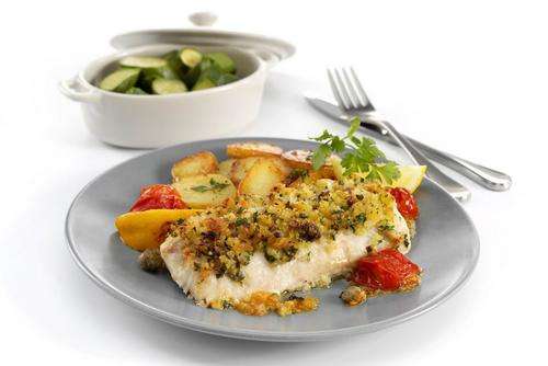 a plate of food with a bowl of vegetables and a fork and Haddock Loin