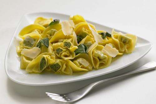 a plate of pasta with cheese, basil, Spinach & Ricotta Tortelloni